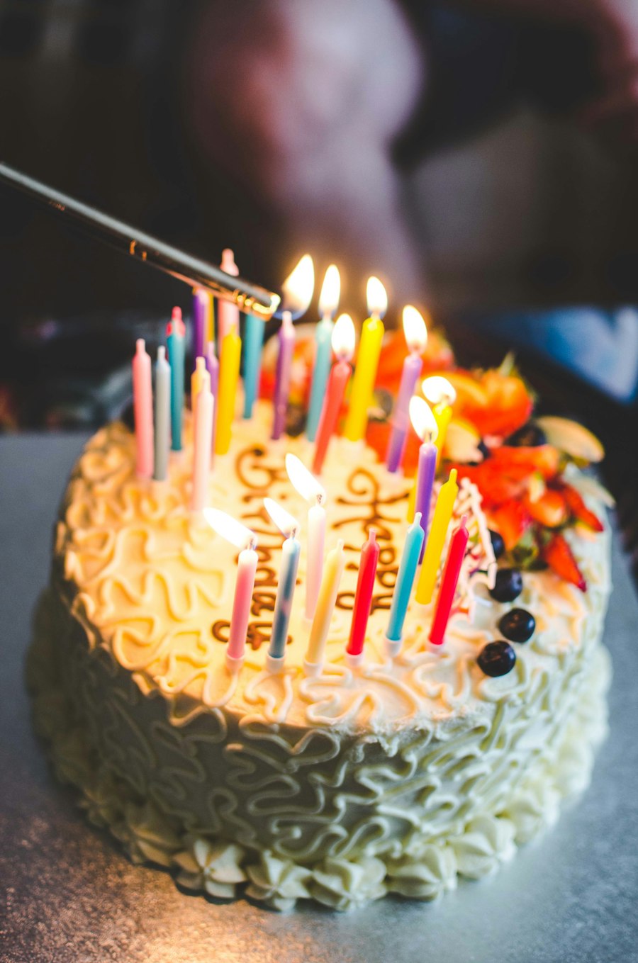 Candles being lit on a birthday cake